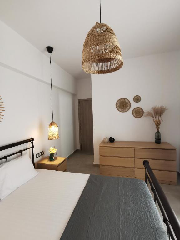 a bedroom with a bed and a pendant light at Mantalena's house in Antiparos