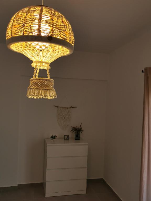 a large chandelier hanging over a dresser in a room at Mantalena's house in Antiparos