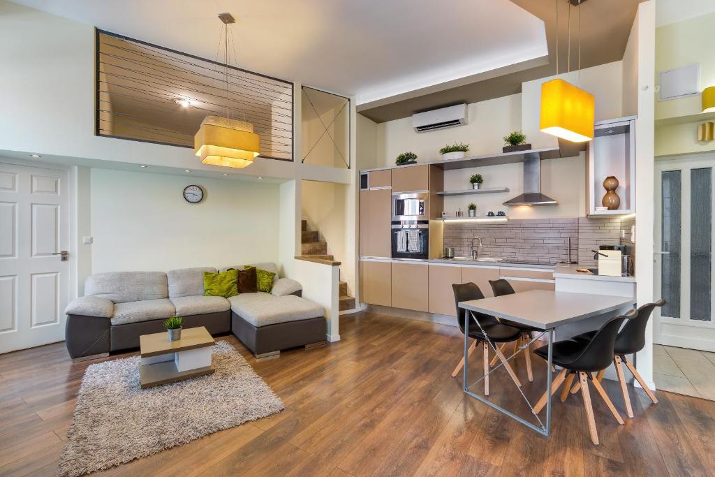 Spacious & stylish apartment in downtown Budapest في بودابست: غرفة معيشة مع أريكة وطاولة