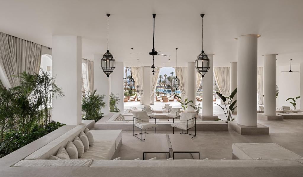 a dining room with a table and chairs in a building at Serry Beach Resort in Hurghada