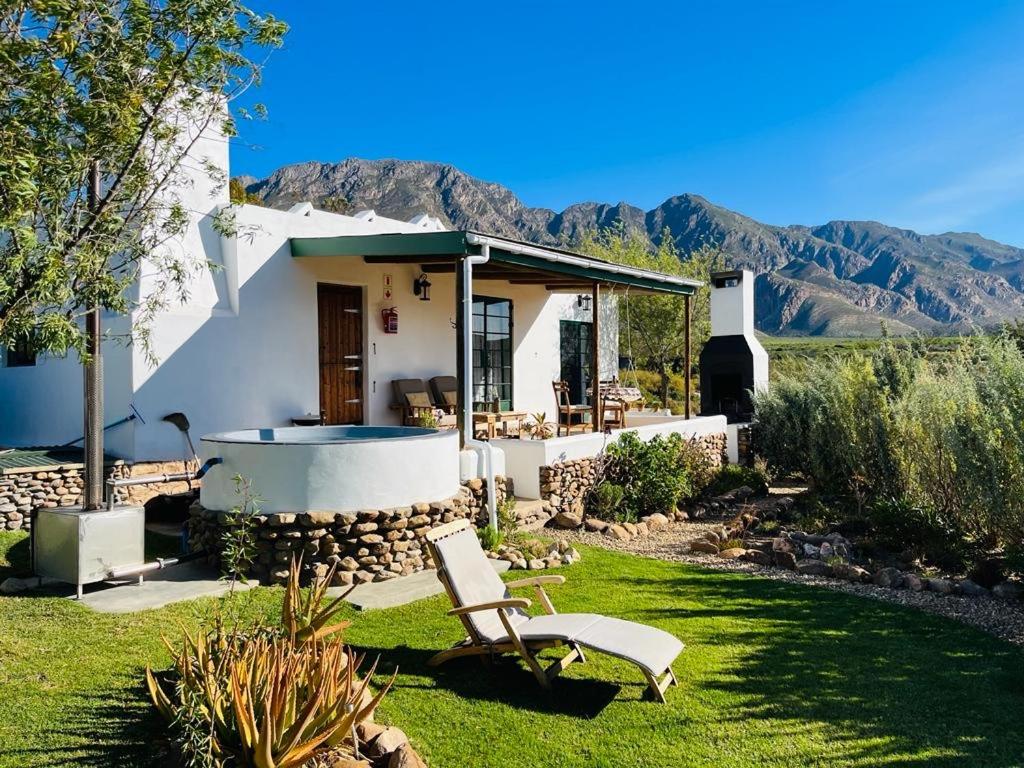 a house with a hot tub in the yard at 360on62 Farm Cottages in Montagu