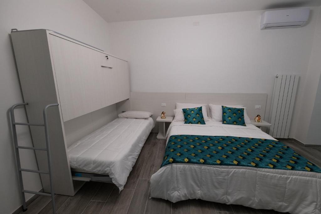 Postel nebo postele na pokoji v ubytování DOMORA BEDROOMS