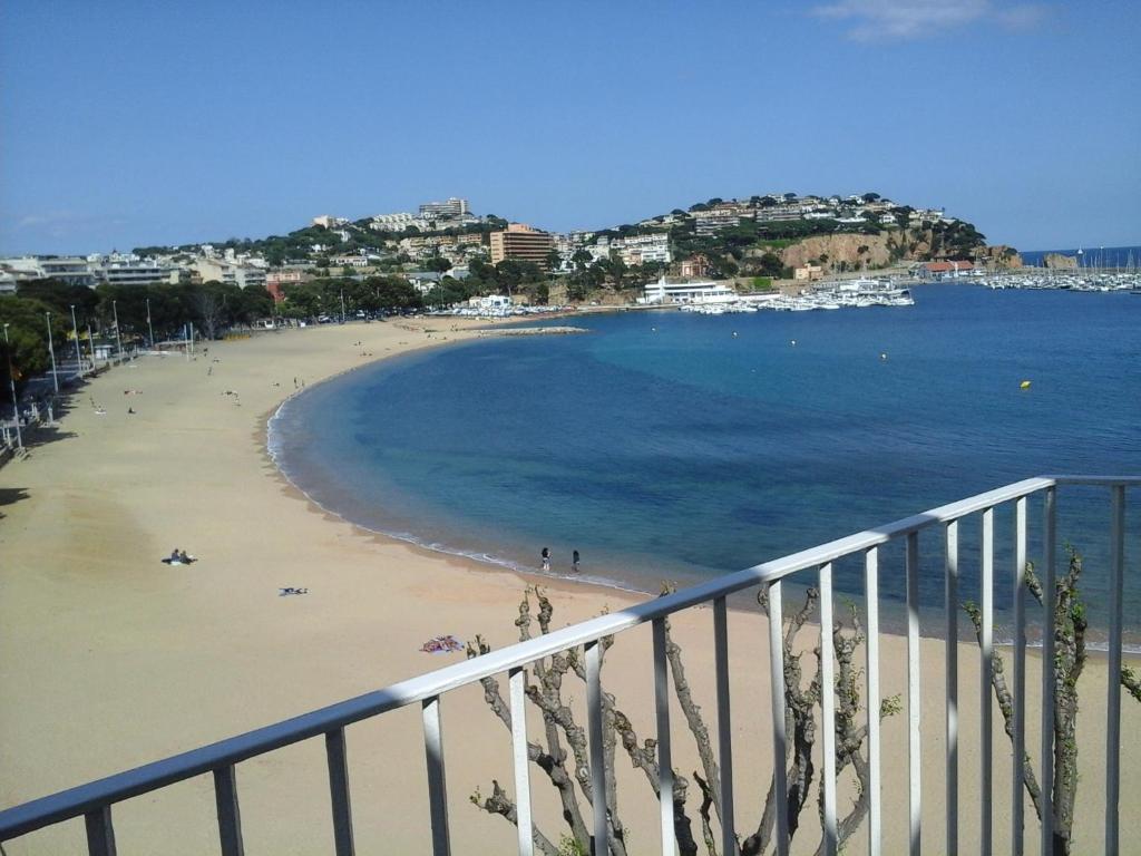 a view of a beach with people on the sand at Apartamentos Siglo XXI - Ancla in Sant Feliu de Guixols