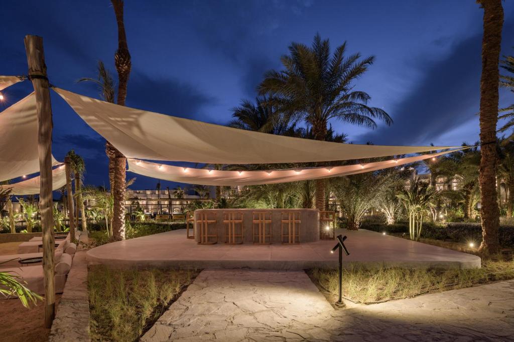a stage with chairs under a tent at night at Serry Beach Resort in Hurghada
