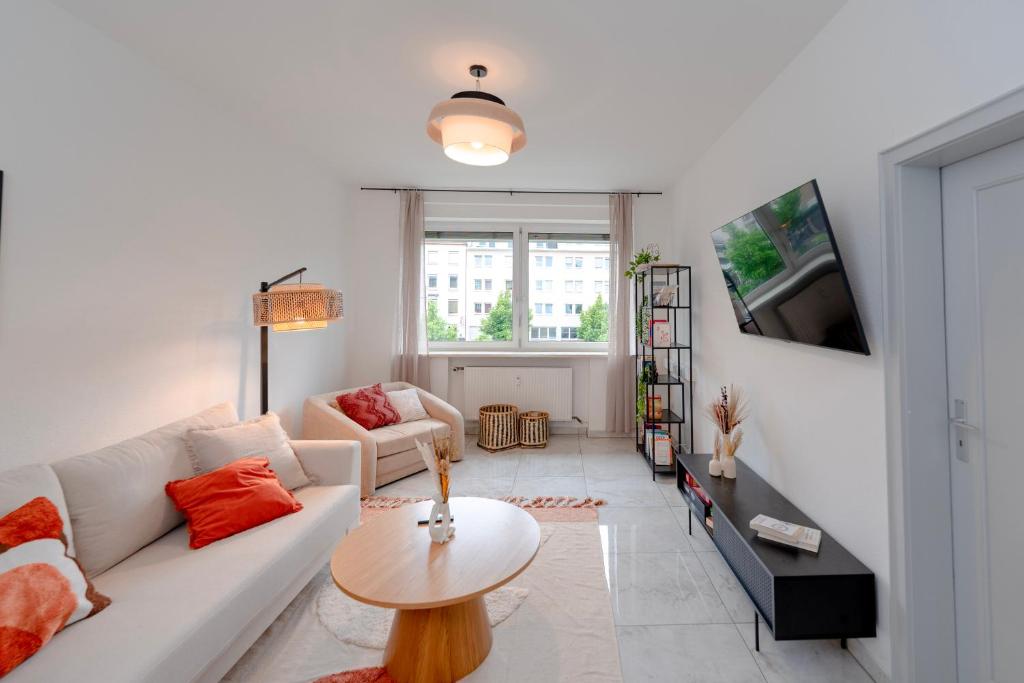 ein Wohnzimmer mit einem weißen Sofa und einem Tisch in der Unterkunft Travelers Dream Heart of Mannheim in Mannheim
