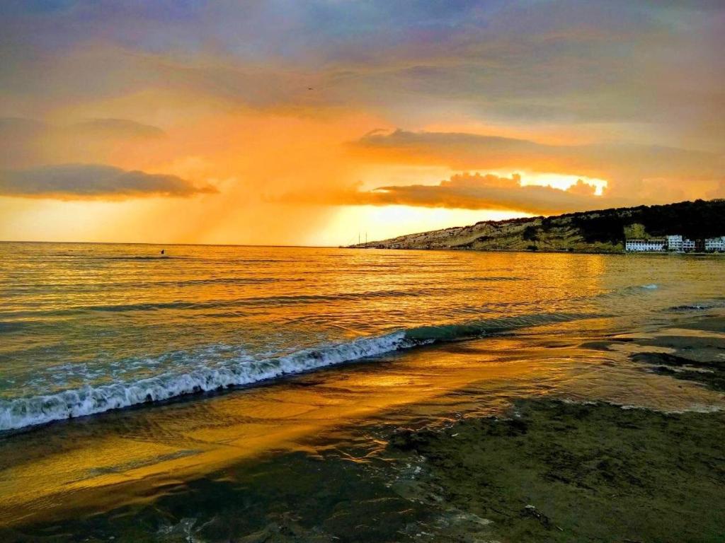 a sunset over a beach with the ocean at Apartments Art in Ulcinj