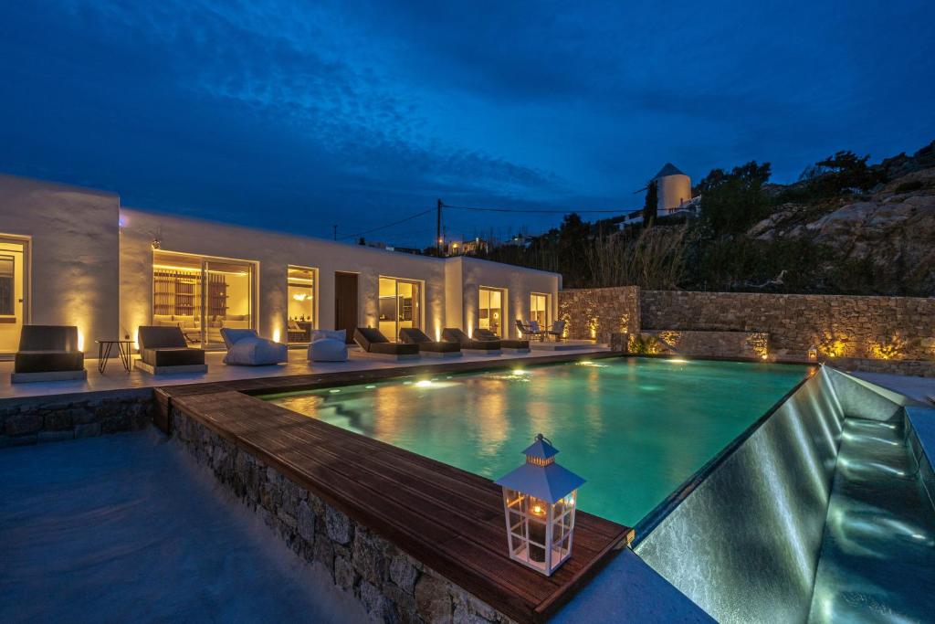 a swimming pool in a house at night at Elit Villa Psarou in Psarou