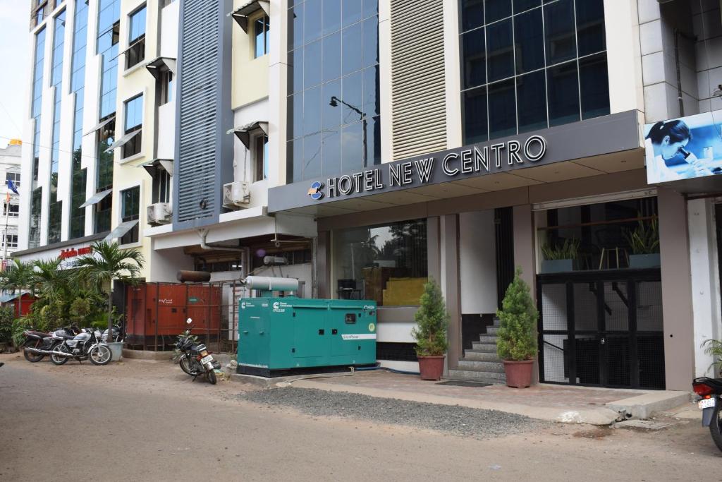 a building with motorcycles parked in front of it at Hotel New Centro in Gulbarga