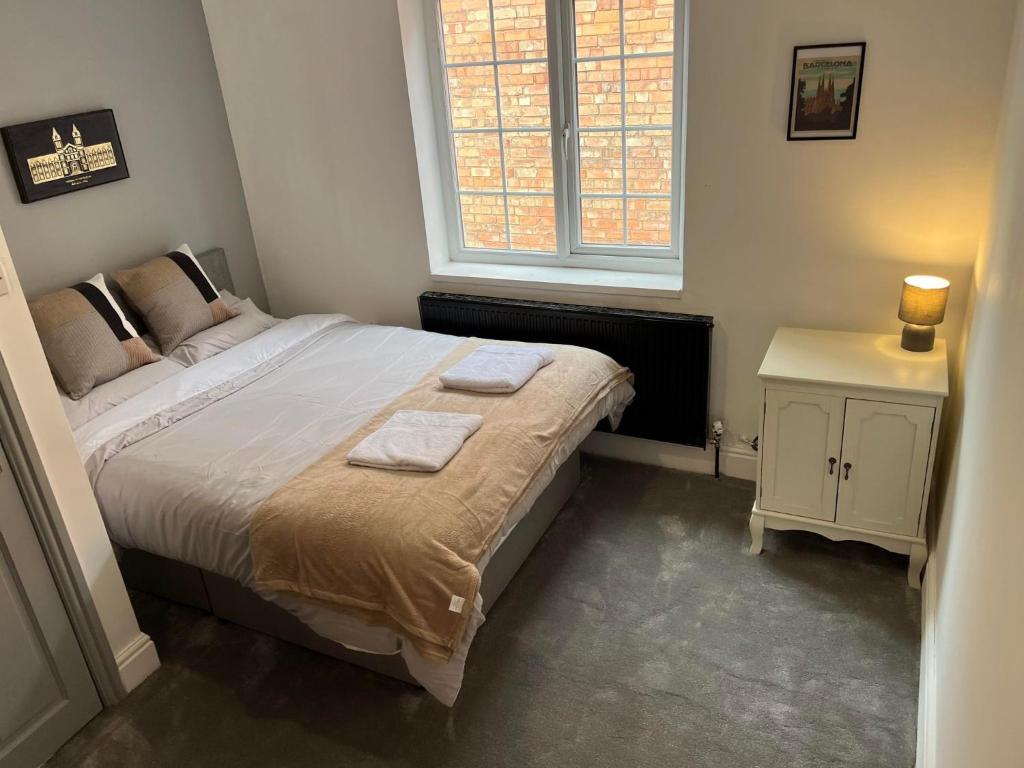 a bedroom with a large bed and a window at Willow House in Birmingham