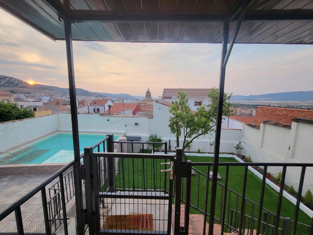 a view from the balcony of a house with a swimming pool at Casa Rural Oasis, una casa rural en Puertollano, agradable, con Piscina en zona tranquila in Puertollano