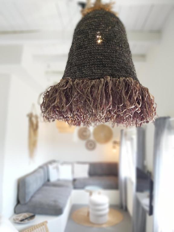 a lamp hanging from the ceiling in a living room at Syros-house in Azolimnos