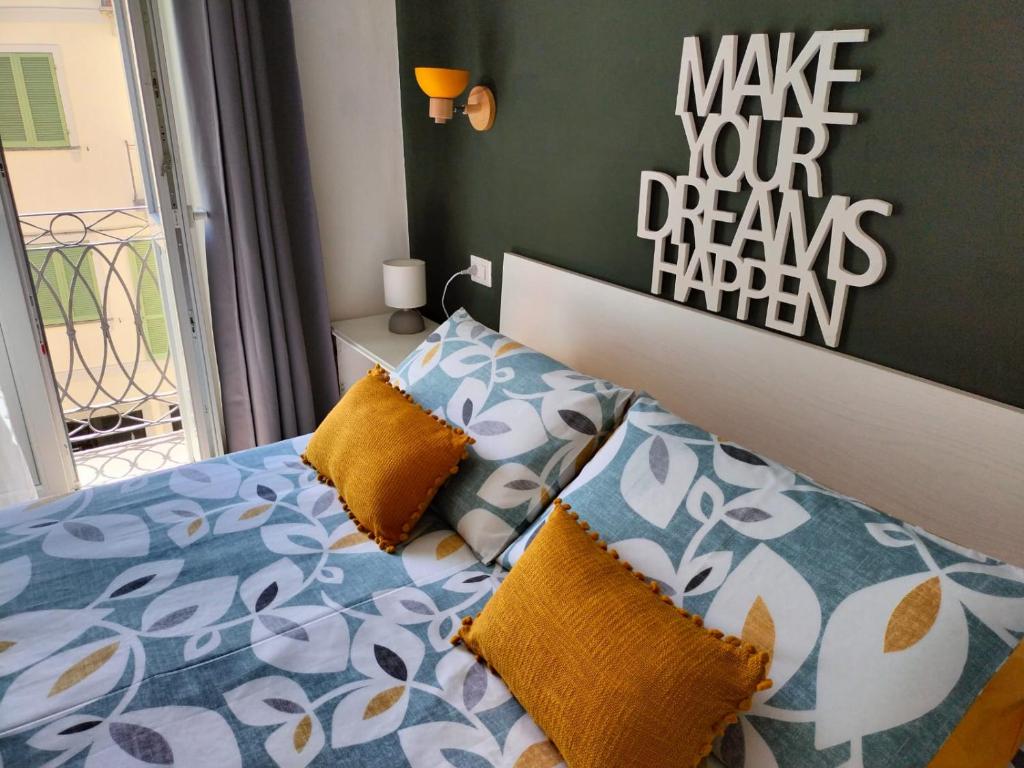 a bedroom with a bed with yellow and blue pillows at Ca' Balenga - Centralissimo con posto auto coperto gratuito in Asti