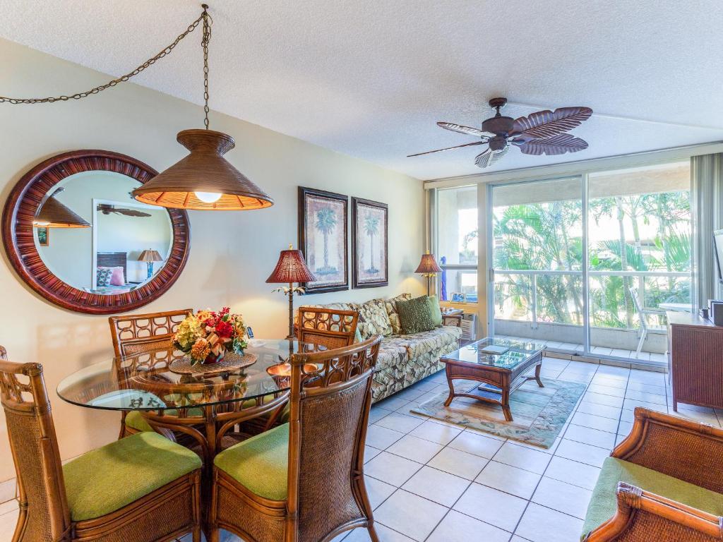 a living room with a table and a couch at Maui Banyan in Wailea