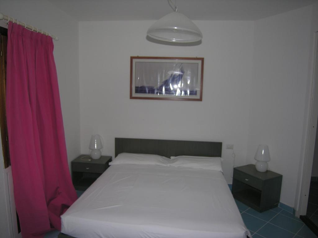 เตียงในห้องที่ Residence Le Terrazze