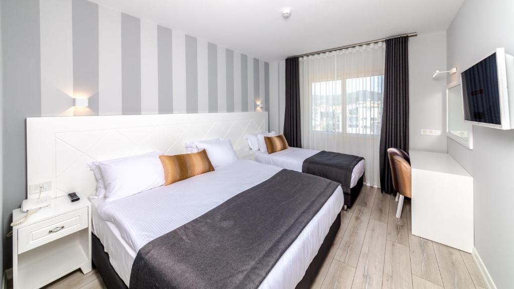 Кровать или кровати в номере Motto Premium Hotel&Spa