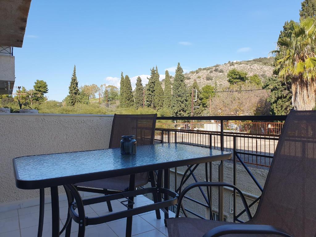 a table and chairs on a balcony with a view at GM Apartments in Tolo