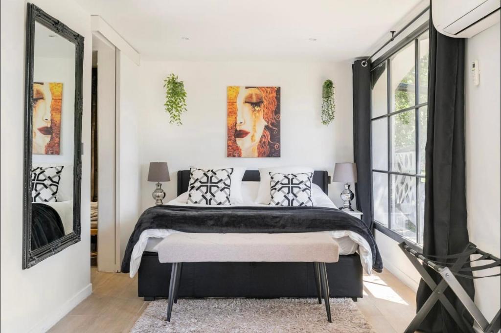 ein Schlafzimmer mit einem Bett und einem großen Fenster in der Unterkunft Suite Bastide Magdaleyna Mougins in Mougins