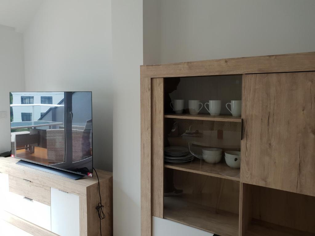 a wooden cabinet with plates and bowls in it at Piedad Fernandez Fernandez Gestion de Inmuebles V in Barreiros