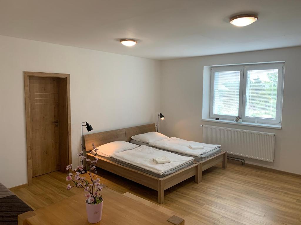 a bedroom with a bed and a window at Apartmány Bolevec Plzeň pro rodiny s dětmi a zvířátky in Pilsen