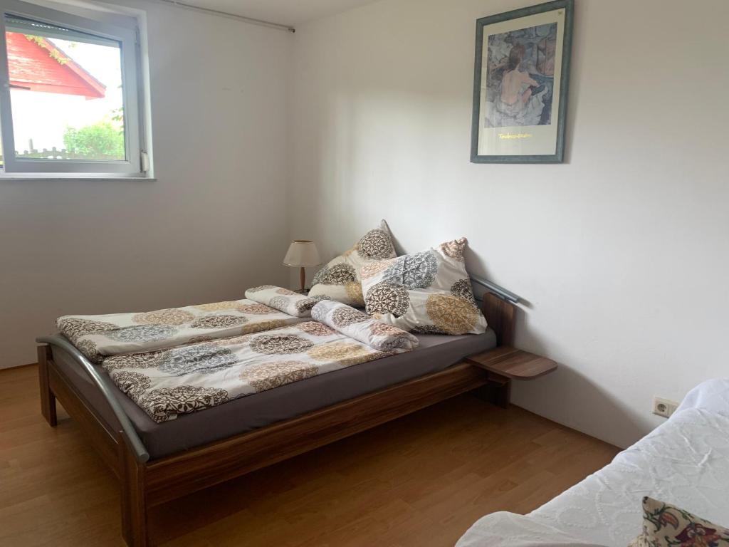 a bed with pillows on it in a room at Haus Idylle Weindorf Duchroth - Helle Souterrain Ferienwohnung in Duchroth