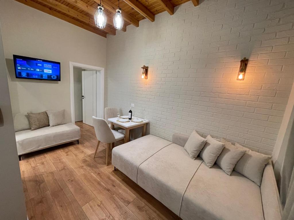 a living room with a couch and a table at Vila Arial in Vlorë
