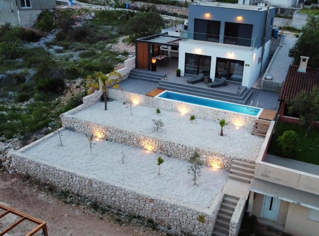 an aerial view of a house with a swimming pool at Golden residence with heated pool in Vinišće