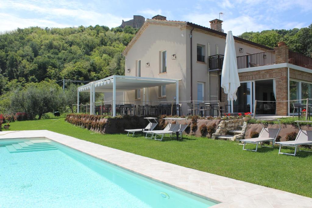 Villa con piscina frente a una casa en Agriturismo La Pedrosa en Montefiore Conca