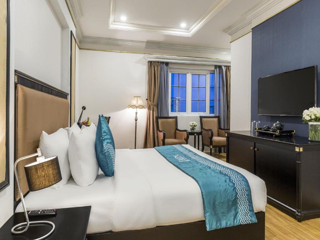 Postel nebo postele na pokoji v ubytování IBIZA Riverfront Da Nang Hotel