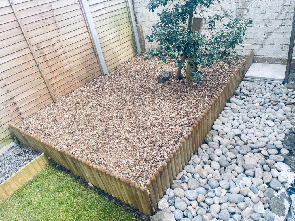 a garden with a small tree and rocks at Small Doble, Shared House in Bristol
