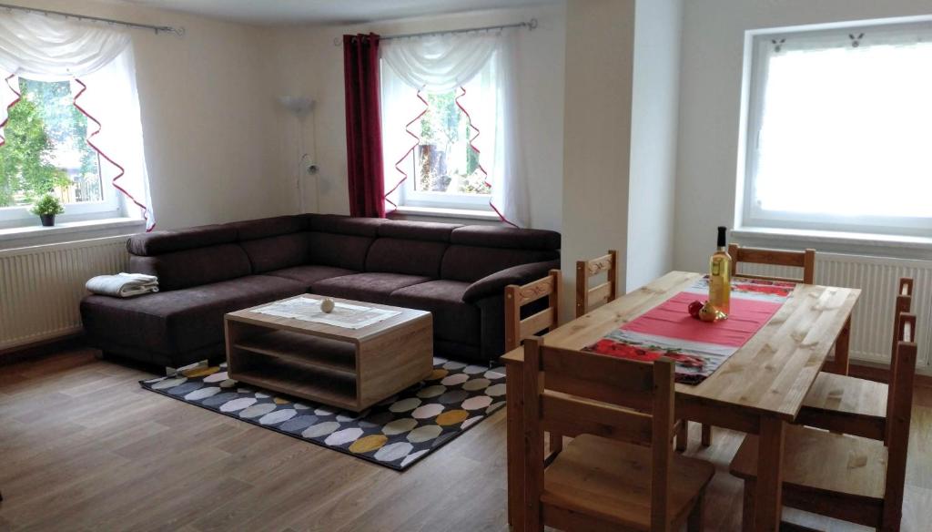 a living room with a couch and a table at Ferienwohnung Berger in Reinhardtsdorf