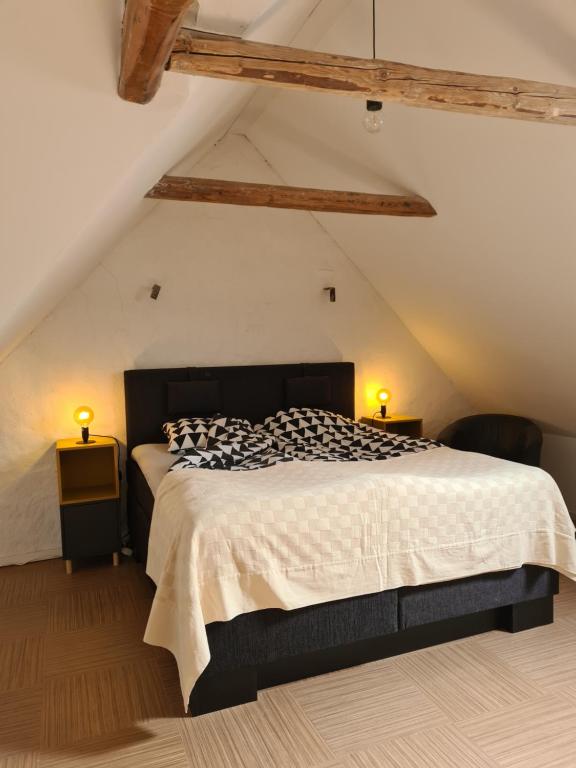 um quarto com uma cama grande num sótão em Lgh centralt i Ystad em Ystad