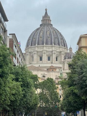 a large building with a dome on top of it at casa san Pietro in Rome