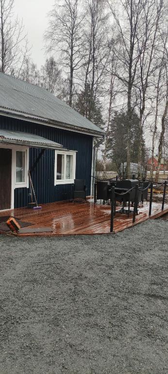 a large wooden deck in front of a house at Villa Pikkumustikka in Töysä