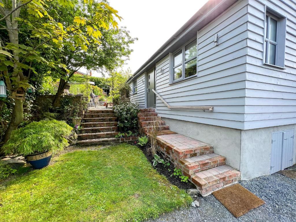 a house with stairs leading up to a house at Tern Cottage in Groomsport