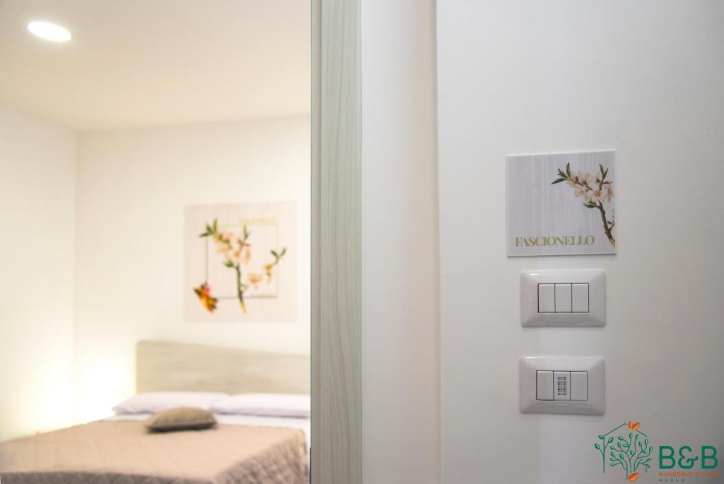 Postel nebo postele na pokoji v ubytování B&B MANDORLO BIANCO