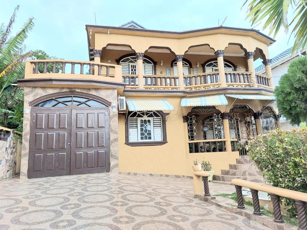 a large house with a balcony on top of it at Cambridge mi casa ur casa with pool and beach access in Runaway Bay