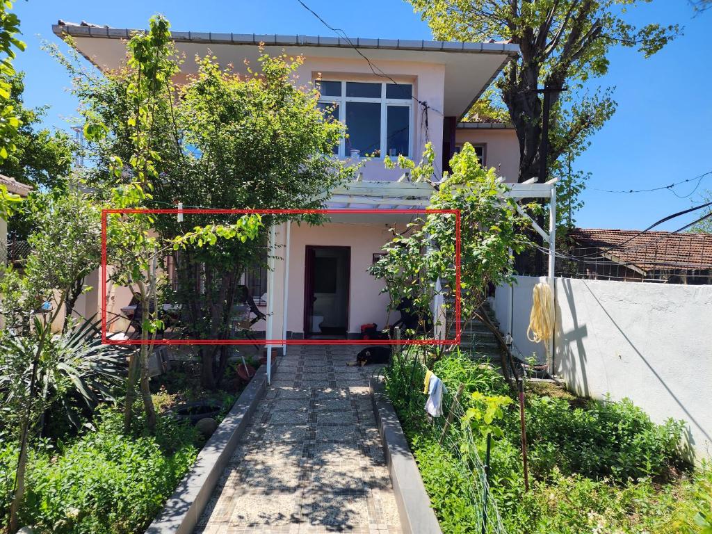 a house with a red ribbon in front of it at Two Bedroom Flat in the Garden at the Bosphorus in Istanbul
