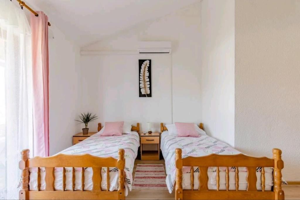 Posteľ alebo postele v izbe v ubytovaní Apartmani Račić