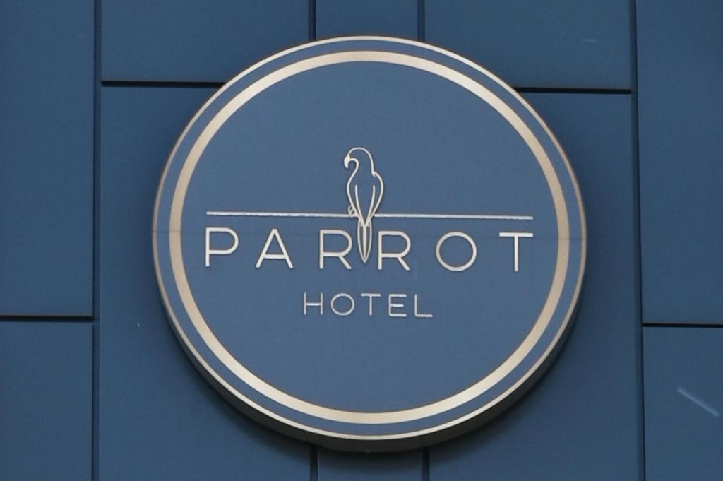 a sign for a parrot hotel on a building at Hotel Parrot in Raszyn