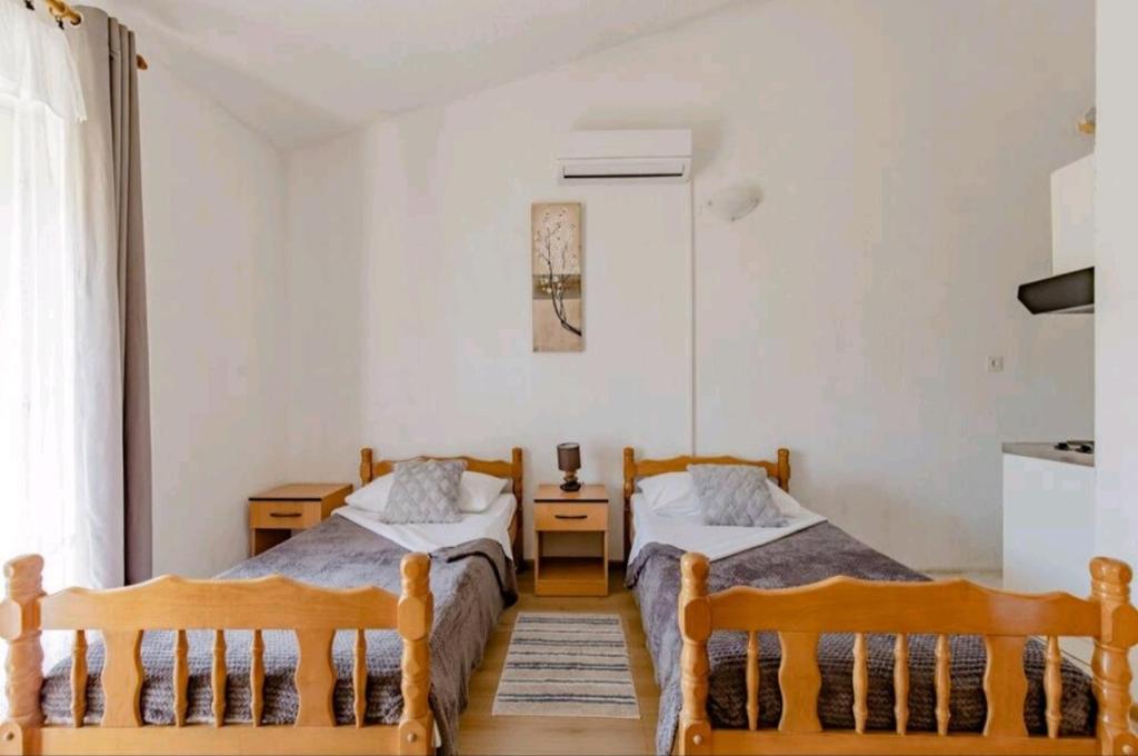 Posteľ alebo postele v izbe v ubytovaní Apartmani Račić