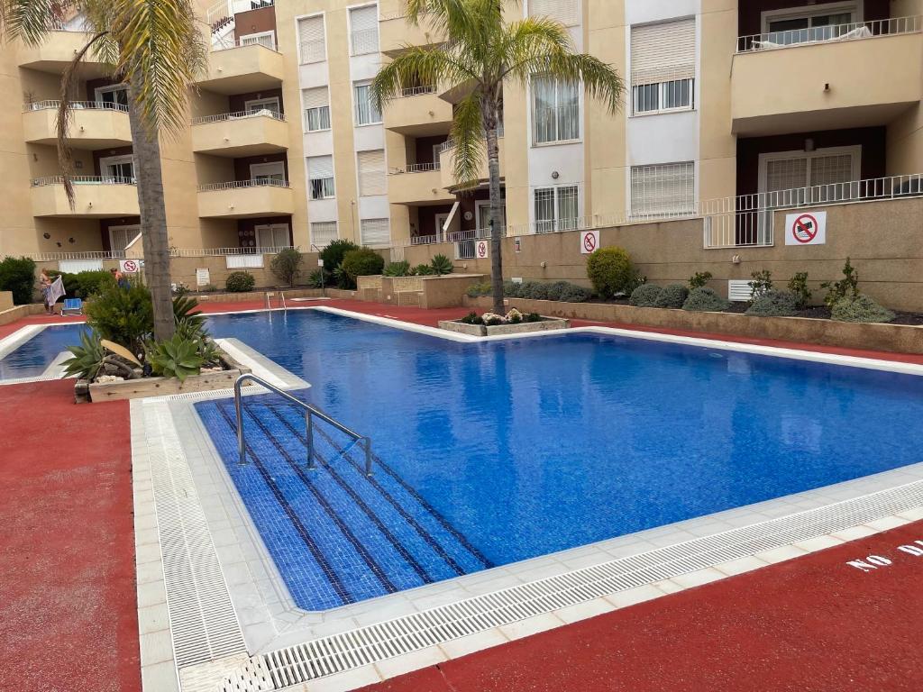 a large blue swimming pool in front of a building at Holiday Home Amari - Residencia Albatros in Los Alcázares