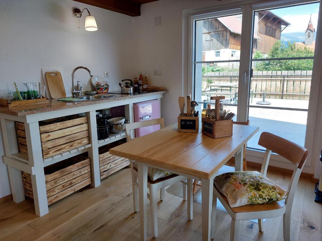 a kitchen with a wooden table and a sink at Graslandhof in Neumarkt in Steiermark