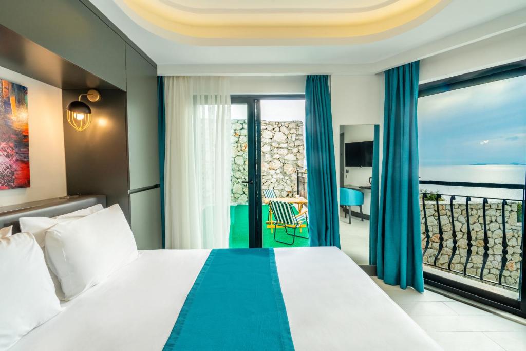a hotel room with a bed and a balcony at Gümüş Yazar Hotel in Kaş
