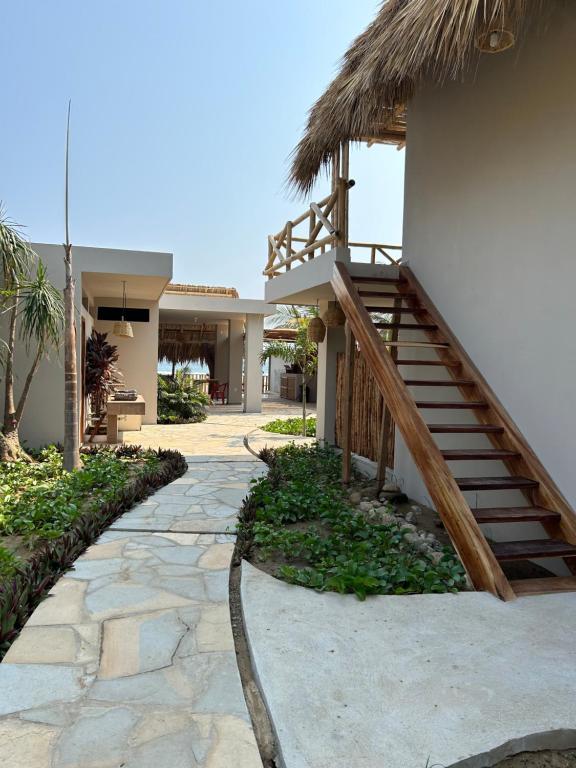 a path leading to a house with a staircase at Mare mío Hotel Boutique in Puerto Arista