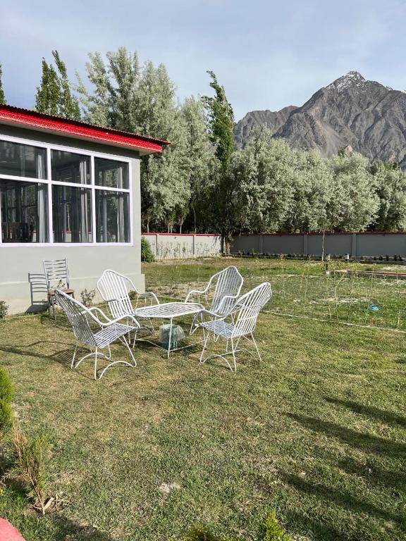 a group of chairs and a table in a yard at Royal Resort Skardu in Skardu