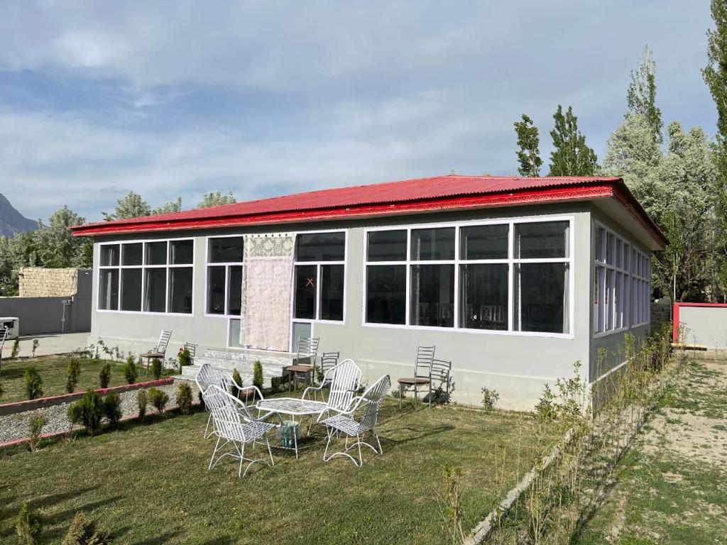 a house with a table and chairs in the yard at Royal Resort Skardu in Skardu