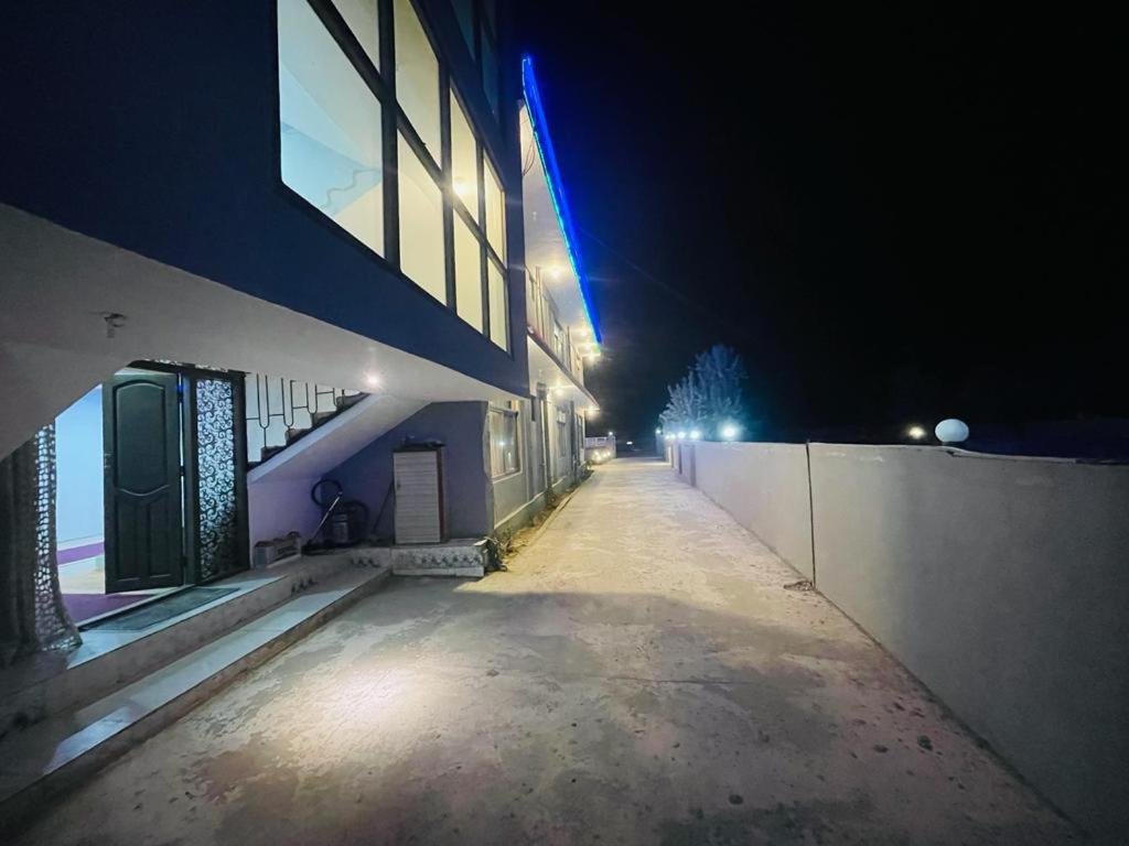 an empty street at night next to a building at Royal Resort Skardu in Skardu