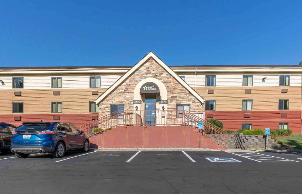 a building with a car parked in front of it at Extended Stay America Suites - Lexington - Tates Creek in Lexington