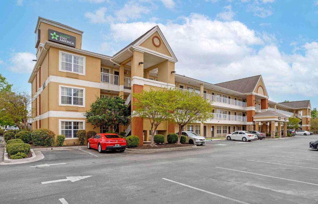 a hotel with cars parked in a parking lot at Extended Stay America Suites - Huntsville - US Space and Rocket Center in Huntsville