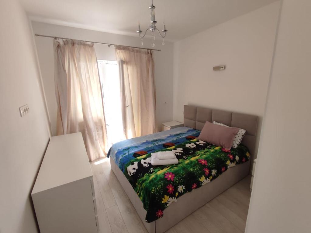 a bedroom with a bed with a cow blanket at Квартира ЖК Милениум парк in Promyshlennyy